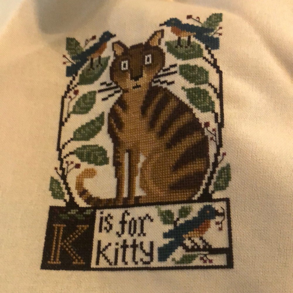 Unframed cross stitch piece on linen